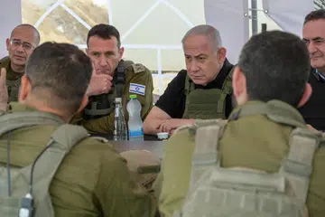 Perdana Menteri Israel, Encik Benjamin Netanyahu (tiga dari kiri), ketika melawat Gaza pada 19 November, menawarkan ganjaran AS$5 juta ($6.7 juta) bagi pemulangan setiap tebusan.