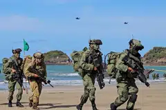 Tentera Angkatan Bersenjata Singapura (SAF) dan Angkatan Pertahanan Australia (ADF) sedang berlari menuju ke kawasan operasi selepas mendarat dari Bot Utiliti Laju (FCU). Sebagai sebahagian daripada Latihan Trident, mereka turut ditemani dua helikopter penyerang ‘Apache AH-64D’.
