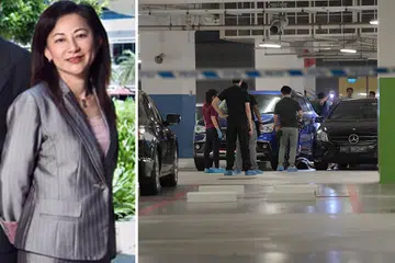 DITIKAM MATI: Polis membawa mayat Cik Low Hwee Geok (kiri) yang telah ditikam mati di tempat meletak kereta ITE Kolej Central pada 19 Julai 2018. - Foto-foto fail