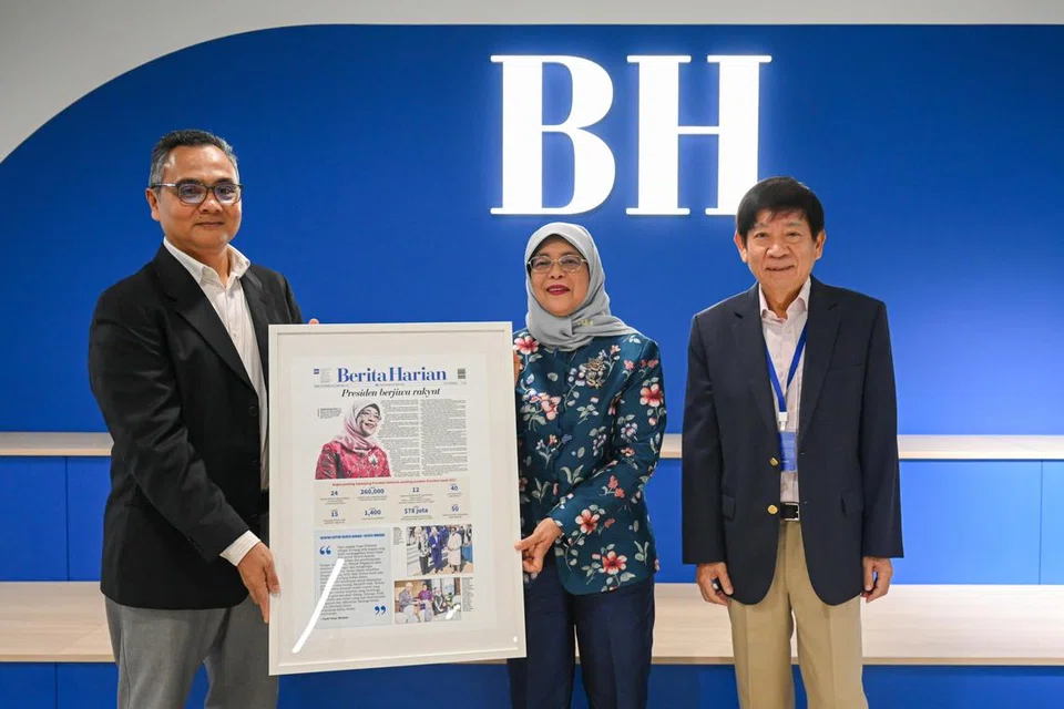 SUMBANGAN DISANJUNG: Editor BH, Encik Nazry Mokhtar (kiri), dan Pengerusi SPH Media Trust, Encik Khaw Boon Wan, menyampaikan cenderamata kepada mantan Presiden Singapura, Puan Halimah Yacob. 