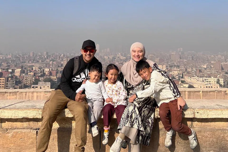 Cik Nurul Huda Abdul Wahid, yang menetap di Dubai sejak 2022, bergambar bersama suaminya Encik Muhammad Redzuan Rashid (kanan), seorang juruterbang Emirates, dan tiga anak mereka.