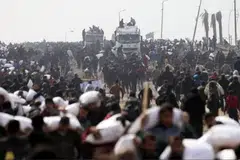 Rakyat Palestin melarikan kampit tepung yang mereka ambil daripada trak bantuan, berhampiran pusat pemeriksaan Israel.