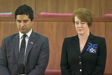 BERTAFAKUR: Pesuruhjaya Tinggi Britain ke Singapura, Cik Kara Owen, dan timbalan beliau, Encik Alex Bamford, di galeri awam di Parlimen semalam. - Foto MCI