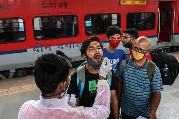 PEMERIKSAAN WARGA: Kakitangan perubatan mengambil sampel calitan bagi menguji keberadaan koronavirus Covid-19 dalam kalangan penumpang kereta api yang tiba di Mumbai, di Maharashtra, dari negeri-negeri lain stesen Dadar, kelmarin. Negeri Maharashtra melaporkan lebih 10,000 kes positif baru pada 23 Jun. - Foto EPA-EFE