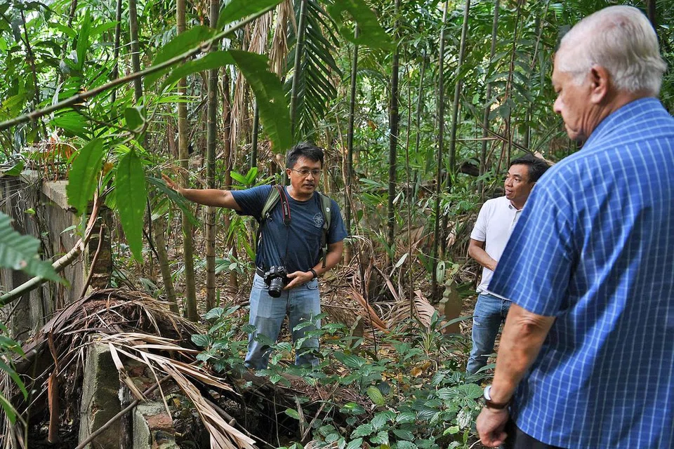 GALI SEJARAH MENERUSI KUBUR: (Dari kiri) Encik Sarafian mengongsi sejarah mengenai tapak perkuburan Marang kepada cicit menantu Allahyarham Abdul Halim Karto, Encik Zaini Rosni, dan mantan Anggota Parlimen, Encik Wan Hussin Zoohri. - Foto BM oleh KHALIB BABA