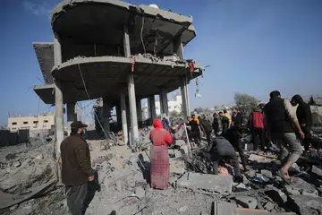 MASIH BERGOLAK: Para penduduk Palestin berusaha mencari mereka yang terselamat selepas pengeboman Israel di kawasan sekitar kem pelarian Khan Younis, selatan Gaza, pada 31 Disember.