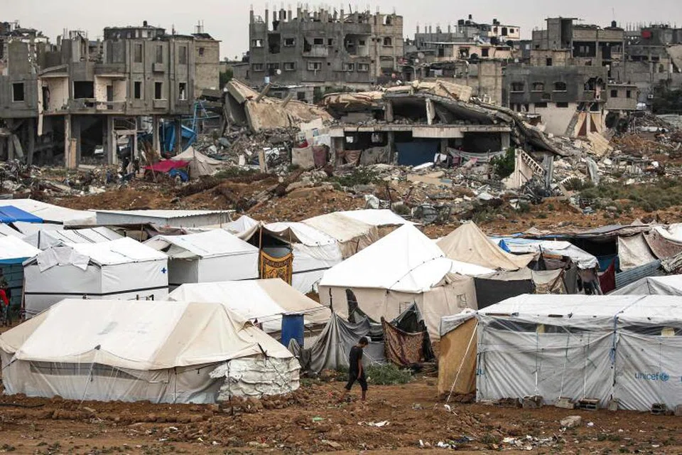 Penduduk Gaza tinggal di khemah yang didirikan berdekatan bangunan yang runtuh dek serangan. Sepanjang setahun lalu, lebih 1.9 juta orang awam telah kehilangan tempat tinggal.