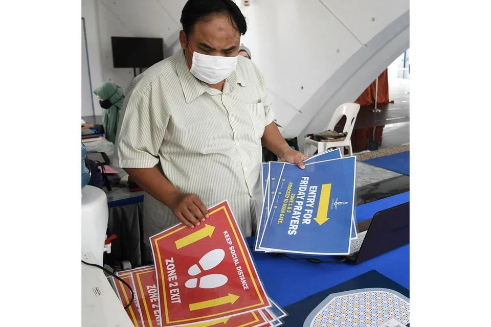 POSTER SEDIAKAN: Encik Izuan Mohamed Rais telah menyediakan pelbagai poster untuk memastikan jemaah tahu arah ke zon masing-masing.