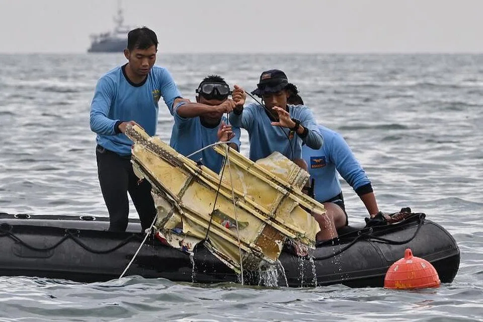 GIGIH DALAM KERJA MENYELAMAT: Beberapa penyelam Tentera Laut Indonesia dalam rangka tugas mencari bangkai pesawat dan serpihan tubuh manusia daripada nahas pesawat Sriwijaya Air. - Fotoi REUTERS