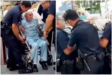 DITAHAN: Zeng ditangkap polis di Orchard Road selepas didakwa mengeluarkan kata-kata kesat terhadap seorang lelaki. - Foto FACEBOOK TITUS KC YAP