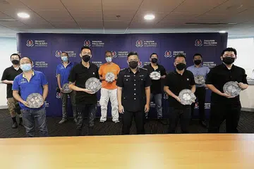 TINDAKAN HALANG SERANGAN DIPUJI: Sembilan lelaki, yang terdiri terdiri daripada kakitangan dapur di restoran berhampiran dan kontraktor yang bekerja berhampiran, serta seorang wanita yang telah menghubungi polis telah diberikan Anugerah Semangat Kemasyarakatan Awam di Divisyen Polis Central semalam. - Foto BH oleh SAMUEL ANG