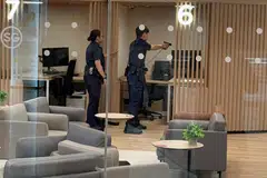 Seorang pegawai polis mengacukan pistolnya ke arah seorang lelaki yang bersenjatakan pisau di Pusat Sivik Woodlands pada pagi 27 Mac.