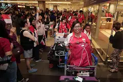 WIRA NEGARA: Atlit memanah wanita negara, Nur Syahidah Alim (depan), selamat pulang ke tanah air bersama kontinjen negara yang bertanding di APG di Jakarta dengan disambut meriah oleh anggota keluarga dan penyokong di Terminal 2 Lapangan Terbang Changi semalam. - Foto BH oleh KELVIN CHNG