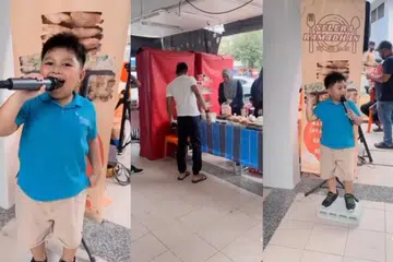 Murid Tadika 2 (K2), Affan Muhammad Amin, menggunakan mikrofon untuk mengajak orang ramai supaya membeli makanan dari gerai keluarganya, Selera Ramadhan by Cik Mah, di Blok 201D, Tampines Street 21.