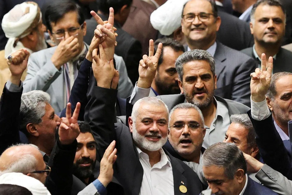 Pemimpin kumpulan Hamas, Encik Ismail Haniyeh (di depan, tengah), ketika menghadiri upacara mengangkat sumpah Presiden baru Iran, Encik Masoud Pezeshkian, di Parlimen Teheran pada 30 Julai.