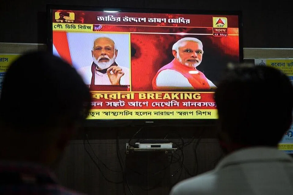 UCAPAN PERDANA MENTERI INDIA: Warga menyaksikan ucapan Encik Narendra Modi kepada seluruh negara menerusi siaran televisyen setelah negara itu melaksanakan perintah berkurung serata negara bagi membendung penularan Covid-19 di Siliguri, semalam. 