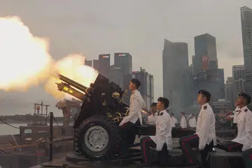 Anggota Angkatan Bersenjata Singapura (SAF) Batalion ke-23, Artileri Singapura, dan Batalion Ke-35, Jurutera Tempur Singapura melepaskan tembakan pertama bagi upacara Tembak Hormat Presiden. 