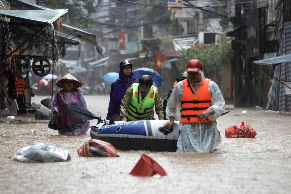 Penduduk menggunakan boya dan sampan untuk berpindah ke tempat lebih selamat ekoran Taufan Yagi yang membawa banjir besar di kawasan utara Vietnam sejak 8 September.