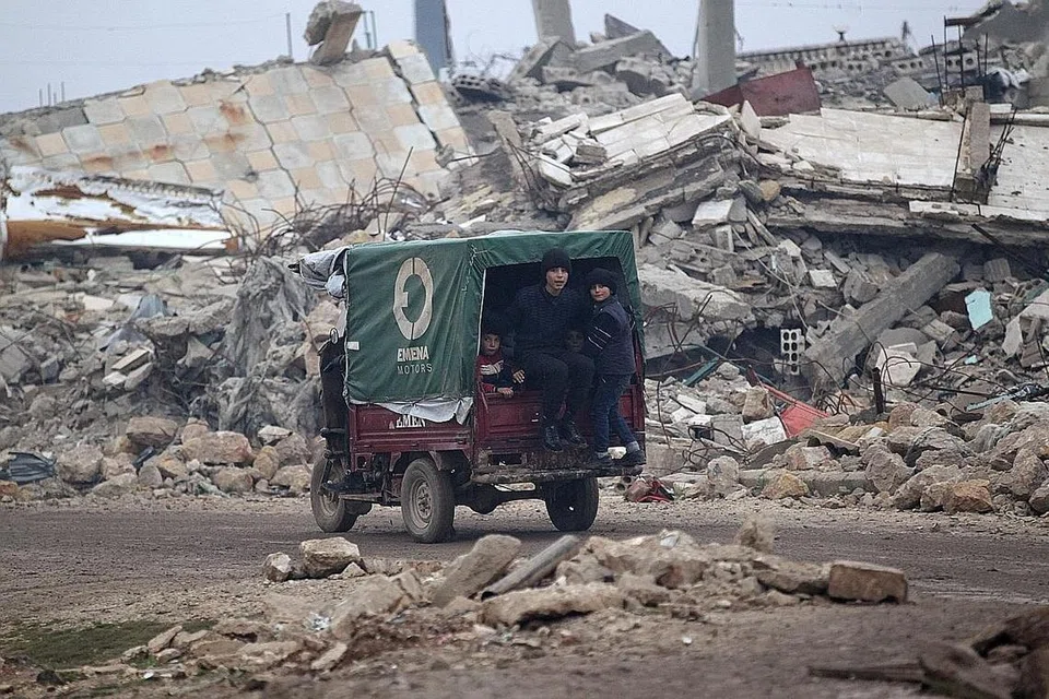 SEMUA RUNTUH: Kanak-kanak ini menaiki kenderaan di tengah-tengah bangunan yang runtuh di bandar al-Rai town, utara Aleppo. - Foto REUTERS