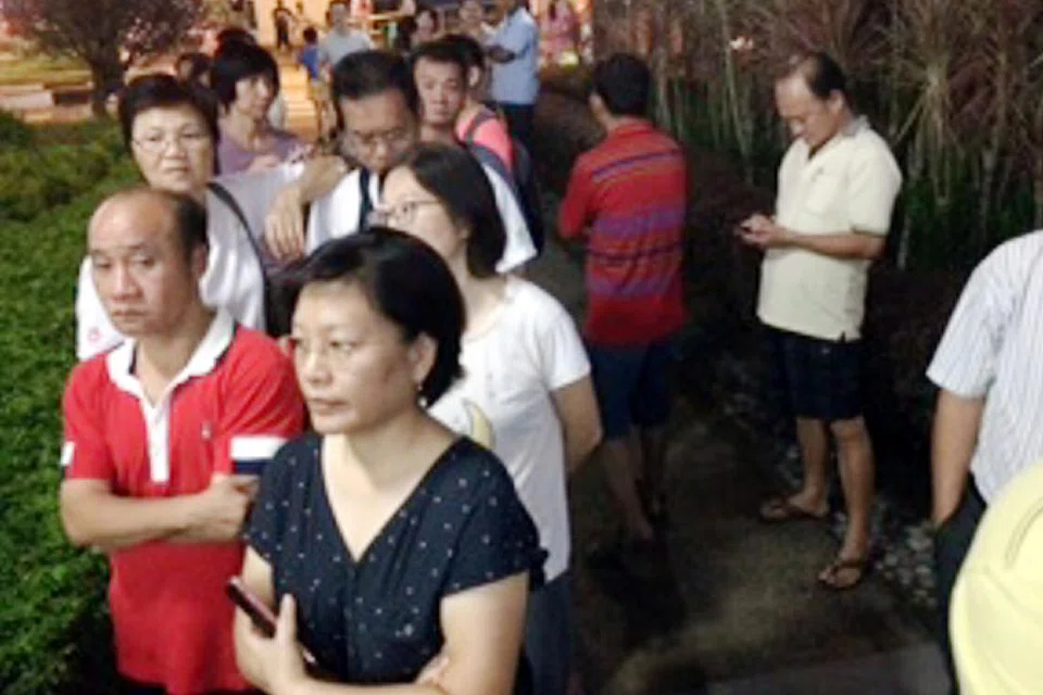 GHAIRAH: Penyokong calon PAP, Encik Murali, berkumpul di luar kawasan pejabat cawangan PAP Bukit Batok. - Foto M.O SALLEH 