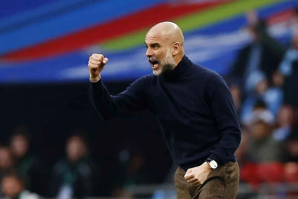Pengurus Manchester City, Pep Guardiola, menunjukkan kegembiraannya selepas pasukannya menjaringkan gol pembukaan dalam perlawanan final Piala Carabao antara Arsenal dengan City di Stadium Wembley, London, 22 Mac.
