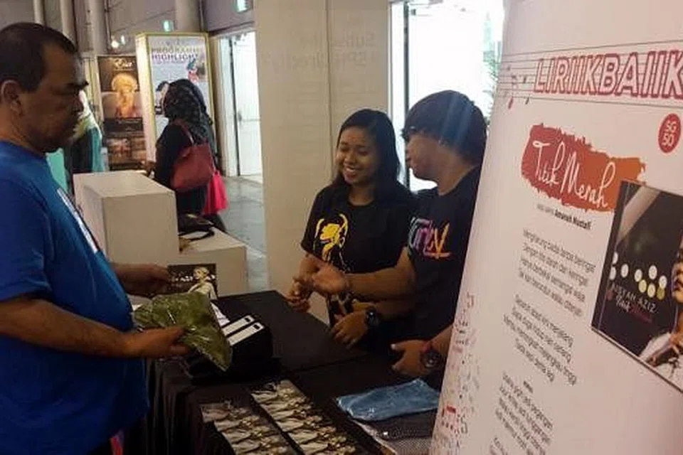 HAYATI LAGU SAMBIL BERAMAL: Encik Samsuri Sareli meluangkan masa membeli CD Titik Merah. - Foto NIZAM ISMAIL