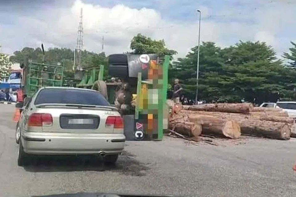 Lori membawa muatan kayu balak terbalik ketika melalui selekoh sehingga menyebabkan seorang penunggang motosikal wanita genting akibat dirempuh kayu balak di Gua Musang, Kelantan.