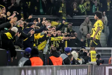 Pemain Dortmund, Karim Adeyemi, meraikan golnya bersama penyokong pasukan ketika menentang Celtic dalam perlawanan Liga Juara-Juara Eropah pada 1 Oktober.
