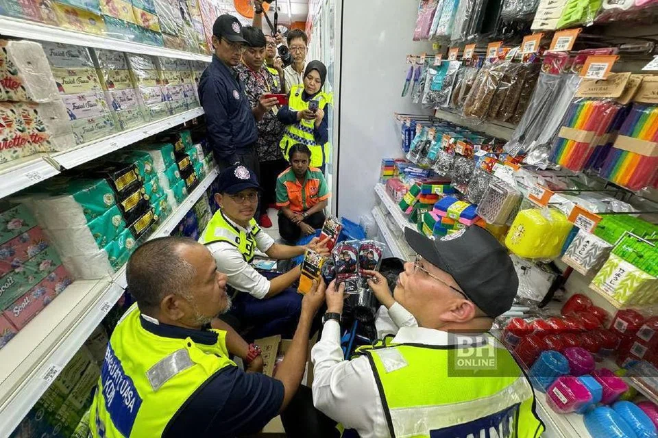Pihak berkuasa Johor memeriksa rak yang menempatkan penjualan stoking yang ada kalimah Allah dikosongkan premis dalam operasi Sepadu Kalimah Allah di beberapa kedai serbaneka di Taman Abad, Johor Bahru, Johor.