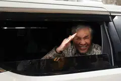 Datuk Seri Dr Ahmad Zahid Hamidi melambai dari dalam kenderaan selepas kekal dilepas dan dibebaskan daripada 40 tuduhan rasuah pada 12 Disember.