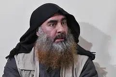 KESAN SERANGAN: Warga Syria menunggang motosikal berdekatan kawasan serangan helikopter yang menyasarkan sebuah kereta dan rumah di wilayah Idlib yang dipercayai didiami "kumpulan berkaitan dengan ISIS". Dalam operasi tentera elit Amerika itu juga, pemimpin ISIS, Abu Bakr al-Baghdadi (gambar atas), dilaporkan meledakkan jaket bunuh dirinya. - Foto AFP