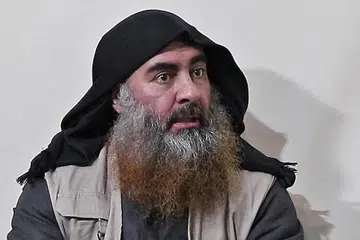 KESAN SERANGAN: Warga Syria menunggang motosikal berdekatan kawasan serangan helikopter yang menyasarkan sebuah kereta dan rumah di wilayah Idlib yang dipercayai didiami "kumpulan berkaitan dengan ISIS". Dalam operasi tentera elit Amerika itu juga, pemimpin ISIS, Abu Bakr al-Baghdadi (gambar atas), dilaporkan meledakkan jaket bunuh dirinya. - Foto AFP