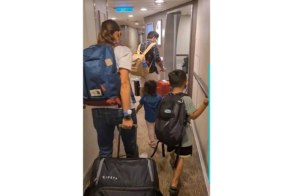 KEADAAN TERATUR: Encik Muhammad Rezal Ramli (pegang kamera) bersama isterinya (kiri bawa beg biru) dan kededua anaknya semasa meninggalkan kabin mereka pada sekitar 9.20 malam. - Foto ihsan MUHAMMAD REZAL RAMLI