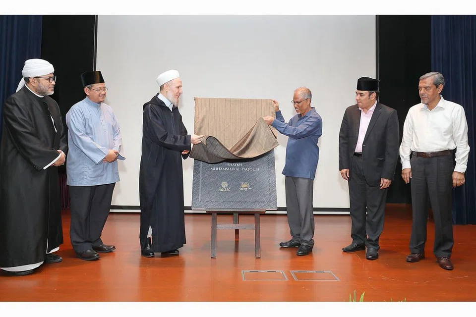 RUJUKAN SANGKAL ISIS: Buku 'Menyangkal ISIS' yang diterjemah ke bahasa Melayu telah dilancarkan oleh Encik Masagos (tiga dari kanan) bersama Shaykh Muhammad Al-Yaqoubi (tiga dari kiri) sambil disaksikan (dari kanan) Ketua Eksekutif Muis, Haji Abdul Razak Hassan Maricar; Dr Mohamed, Mufti Dr Fatris Bakaram, dan Presiden Pergas, Ustaz Mohamad Hasbi Hassan, semalam. - Foto BM oleh JONATHAN CHOO