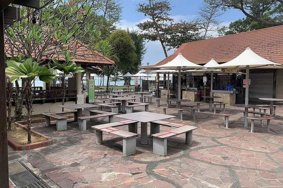 PERNIAGAAN TERJEJAS: Berbeza daripada sebelum sekatan 'pemutus litar', suasana di Pusat Penjaja East Coast sangat sunyi pada hujung minggu ini, dengan hanya segelintir pengunjung yang datang untuk membeli makanan. Mereka perlu membungkus dan membawa pulang makanan itu kerana tidak dibenarkan lagi untuk duduk makan di tempat itu.