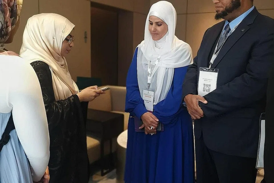 KENANGAN MANIS: Cik Samia Khalil Omar (tengah) berkongsi pengalamannya dalam satu pos yang dimuat naik di Facebook, di mana beliau memuji kebaikan dan sikap peduli "yang tidak ada bandingnya" yang diterima di Singapura. Cik Samia ke Singapura bersama suaminya, Dr. Khalil Abdur-Rashid (kanan), untuk menghadiri Persidangan Antarabangsa Masyarakat Gemilang (ICCOS). - Foto FACEBOOK SAMIA KHALIL OMAR