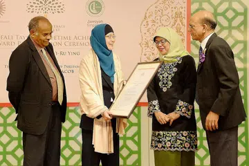 SUMBANGAN DIIKTIRAF: Profesor Ying (dua dari kiri) menerima anugerah daripada tetamu terhormat, Cik Halimah, dengan diperhatikan Encik Ameerali Abdeali (kanan) dan Encik K. Kesavapany daripada Lembaga Endowmen Hindu. - Foto ZAINAL YAHYA