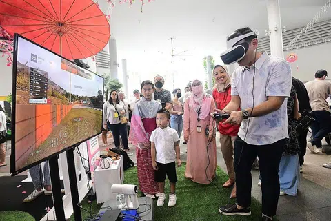 PEMBELAJARAN SEPANJANG HAYAT: Merasmikan pesta itu, Encik Zaqy (kanan) telah mengadakan lawatan ke Pesta Pembelajaran 2022, anjuran Mendaki di Kampung Admiralty semalam. Beliau dilihat mencuba stesen permainan VR. - Foto MENDAKI