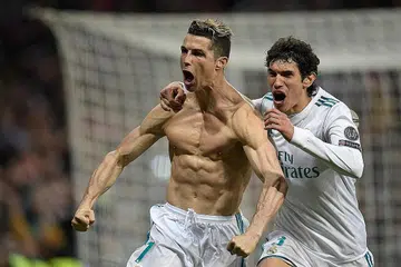 'SUPER-NALDO': Bintang Real Madrid, Cristiano Ronaldo, menanggalkan jersinya di padang sebelum berlari kegembiraan selepas gol penaltinya menjamin tempat pasukannya di separuh akhir Liga Juara-Juara. - Foto AFP