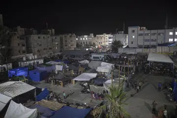 TEMPAT BERLINDUNG: Penduduk Palestin yang hilang tempat tinggal, mencari perlindungan di bangunan dan kem yang didirikan di perkarangan sekolah kelolaan Pertubuhan Bangsa-Bangsa Bersatu di Khan Younis, selatan Gaza.