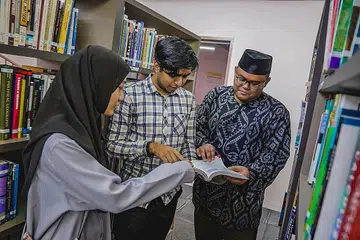 CEMERLANG: Encik Mohamed Hussein Mohamed Saddiq (tengah) dan Cik Siti Anissa Abdul Rashid antara pelajar kohort pertama Program Diploma International Baccalaureate (IBDP) Madrasah Aljunied. Kanan ialah guru Matematik, Encik Abdul Malek Razali - Foto BH oleh NUR DIYANA TAHA