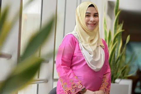 KAEDAH PEMBELAJARAN KREATIF: Cik Diana Mohamed Mazlan yang masih hamil semasa gambar ini diambil telah mencipta pelbagai kaedah pebelajaran yang kreatif termasuk permainan kad bagi membantu murid menghafal peribahasa dan kosa kata. - Foto BH oleh NG SOR LUAN
