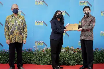 RAI PENCAPAIAN: Timbalan Perdana Menteri Heng Swee Keat menyampaikan anugerah kepada Cik Reena, dalam majlis hibrid Anugerah Mendaki semalam. - Foto BM oleh GAVIN FOO