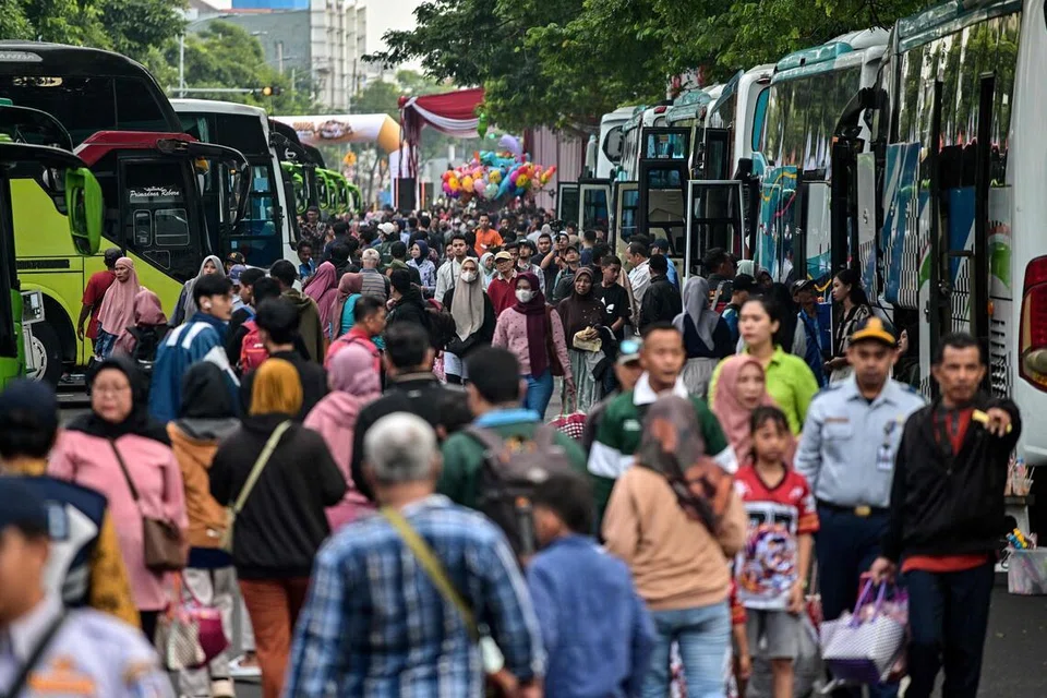 Orang ramai tiba untuk menaiki bas percuma yang disediakan oleh pemerintah bagi pulang ke kampung halaman menjelang Aidilfitri, yang menandakan berakhirnya bulan puasa Ramadan, di Surabaya pada 19 Mac 2026. 
