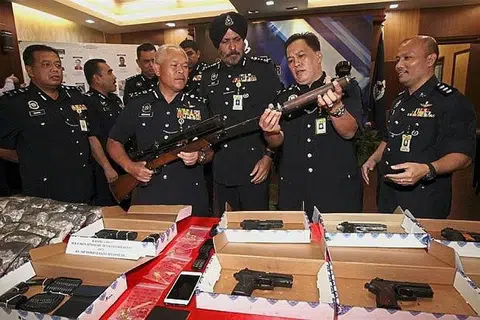 DIRAMPAS: Pengarah Jabatan Siasatan Jenayah Bukit Aman Datuk Seri Mohmad Salleh (dua dari kiri) menunjukkan raifal yang dirampas dalam Ops Cantas Khas Jenayah Terancang pada sidang akhbar di Ibu Pejabat Polis Kontinjen Kuala Lumpur. - Foto THE STAR