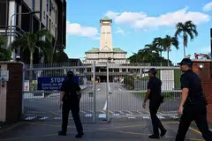 Polis dilihat memasuki perkarangan Gereja St Joseph’s pada 21 Disember.