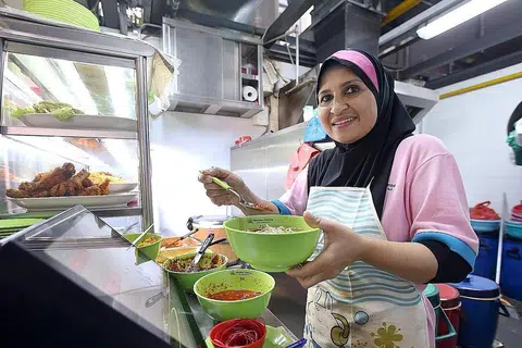 SEDIAKAN PILIHAN LEBIH SIHAT UNTUK PELANGGAN: Cik Salma Salim menyediakan mi soto lebih sihat dengan, antara lain, membuang lemak ayam dan tidak menggunakan minyak bagi menghasilkan kuahnya. - Foto MCI