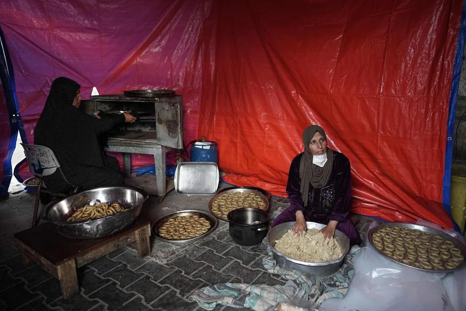 Wanita Palestin ini sibuk memasak juadah Raya seadanya untuk dihidangkan pada Aidilfitri yang dijangka disambut pada 10 April.