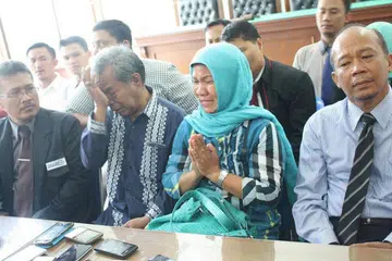 MOHON MAAF: Encik Makmur Hasugian (dua dari kiri) dan isterinya, Cik Arista Purba, memohon maaf kepada penganut Kristian semasa sidang media di Persatuan Peguam Indonesia (Peradi) di Medan kelmarin. - Foto JAKARTA POST