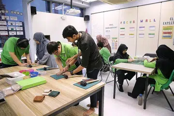 BERSEMANGAT JALANI LATIHAN KEMAHIRAN: Pelajar Hab Pendidikan Khas My Inspiring Journey (MIJ) tekun menjalani latihan menghasilkan kraf tangan yang disediakan bagi mempersiap diri mereka melangkah ke alam pekerjaan. - Foto BH oleh KEVIN LIM